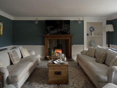 A living room with sofas and a coffee table at Holwell Farmhouse in Bampton