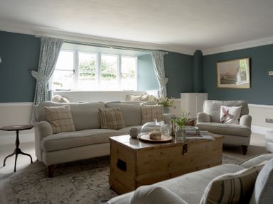 A living room with sofas and coffee table at Holwell Farmhouse in Bampton
