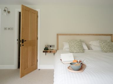 A bedroom with a bed and a bedside table at Holwell Farmhouse in Bampton