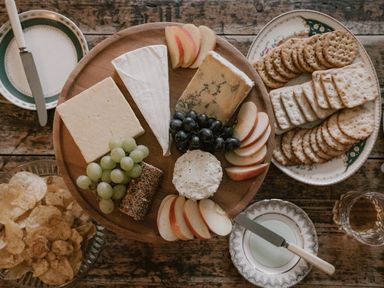 A cheese platter with fruits and crackers at Holwell Farmhouse in Bampton