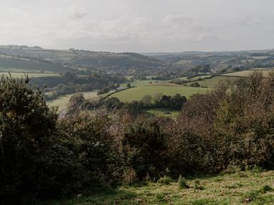 A landscape view of hills and fields at Holwell Farmhouse in Bampton