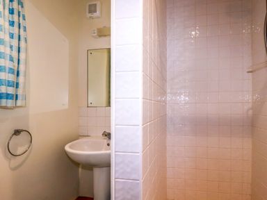 A bathroom with a sink and shower at Rosewin Farmhouse near St Minver