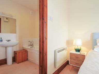 A bathroom with a wash basin and bath at Rosewin Farmhouse near St Minver