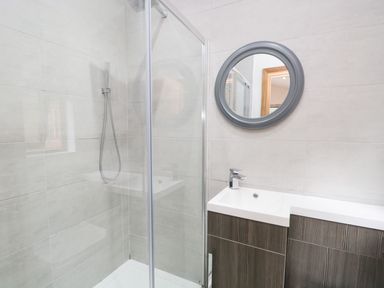 A bathroom with a shower and sink at Easedale Lodge Waterside Wood 2, White Cross Bay near Windermere