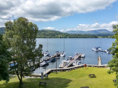 A view of boats docked at a marina by the water at Easedale Lodge, Waterside Wood 2, White Cross Bay near Windermere
