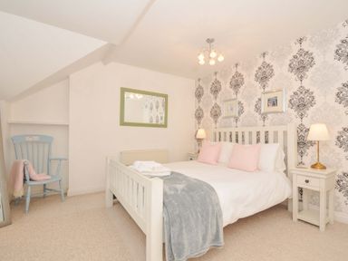 A bedroom with a bed and two bedside tables at Overdale