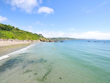A beach with clear water and cliffs in the background at Overdale
