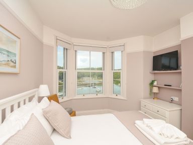 A bedroom with a view of a harbor at Overdale in Looe