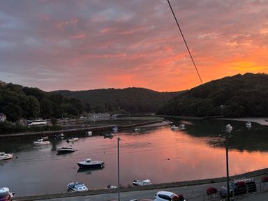A river with boats during sunset at Overdale in Looe