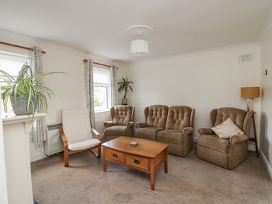 A living room with chairs and a coffee table at Dunbrody Dreams