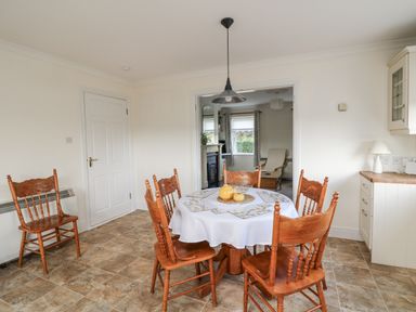 A dining room with a table and chairs at Dunbrody Dreams