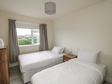 A bedroom with two beds and a nightstand at Dunbrody Dreams