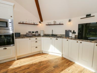 A kitchen with appliances and storage at Yr Awen in Lampeter