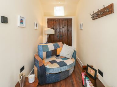 A snug with an armchair and table at Y Cwlwm in Lampeter