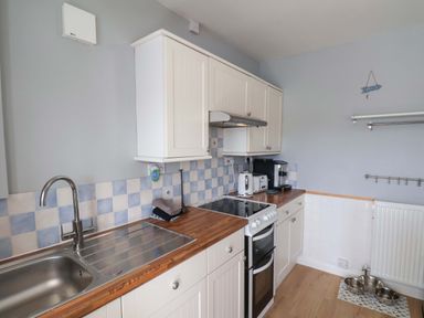 A kitchen with cabinets and appliances at Floraville
