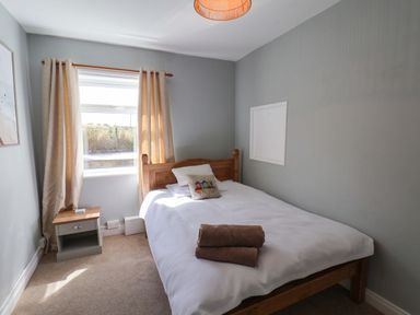 A bedroom with a bed and nightstand at Floraville