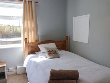 A bedroom with a bed and window at Floraville