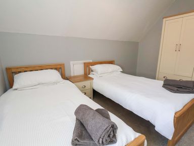 A bedroom with two single beds and a wardrobe at Floraville
