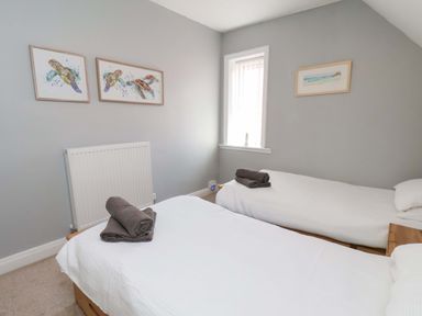 A bedroom with two beds and a radiator at Floraville