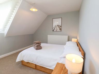 A bedroom with a bed and towels at Floraville