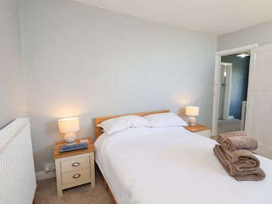 A bedroom with a bed and nightstands at Floraville