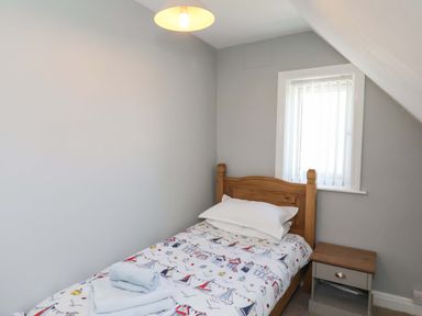 A bedroom with a bed and nightstand at Floraville