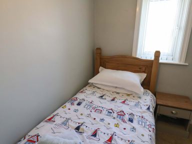 A bedroom with a bed and bedside table at Floraville