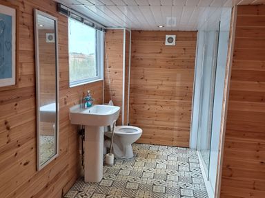A bathroom with a sink, toilet, and shower at Floraville in Cayton Bay