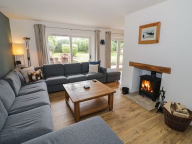 A living room with a fireplace and sofa at Harran in Pershore