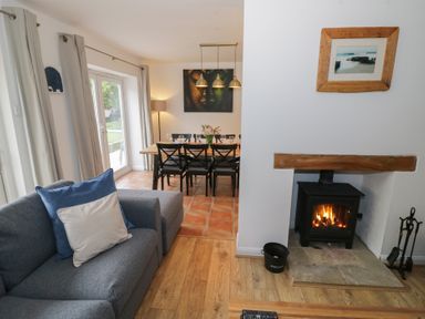 A living room with a sofa and dining area at Harran in Pershore