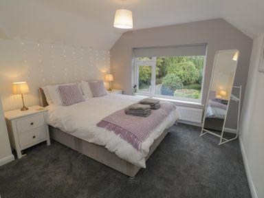 A bedroom with a bed and a window at Harran in Pershore