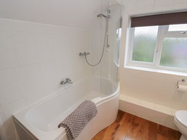 A bathroom with a bathtub and shower at Harran in Pershore