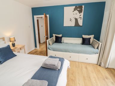 A bedroom with a bed and daybed at Harran in Pershore