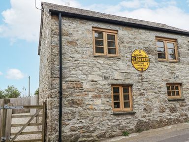 A stone building with windows and a sign at The Old Dairy in 