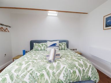 A bedroom with a bed and bedside table at The Old Dairy
