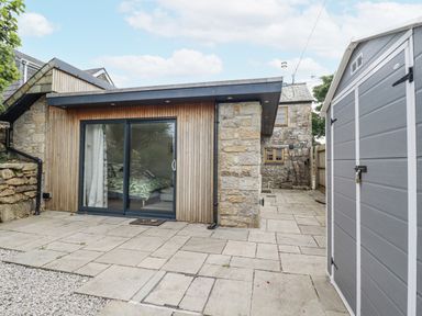 An outdoor area with a sliding door and a shed at The Old Dairy 