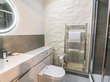 A bathroom with a sink and toilet at Penally Mews in St Dogmaels
