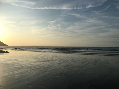 A beach with waves and sunset at Penally Mews St Dogmaels