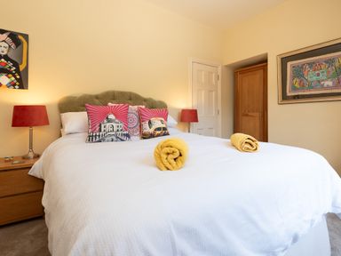 A bedroom with a bed and decorative pillows at The Old Vicarage in St Issey