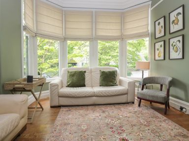 A living room with a sofa and a chair at The Boundary in Windermere