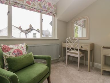 A bedroom with a mirror and desk at The Boundary in Windermere