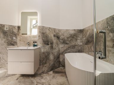 A bathroom with a bathtub and sink at The Boundary in Windermere