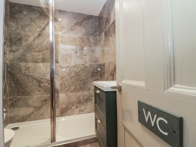 A bathroom with a shower and sink at The Boundary in Windermere
