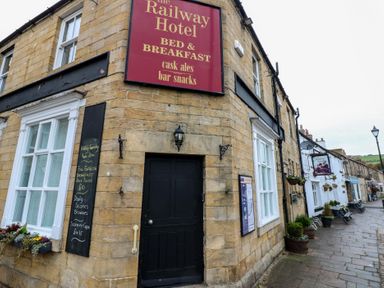 The Railway Hotel sign outside the property at The Railway Apartment in Hexham