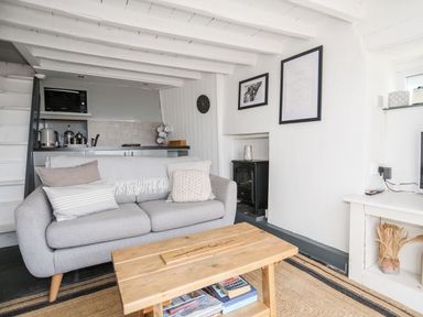 A living room with a sofa and a coffee table at The Ingle in Barmouth
