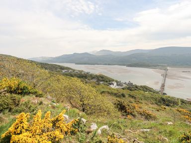 A landscape view with a river and bridge at The Ingle in Barmouth