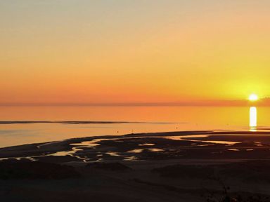A sunset over the ocean at The Ingle in Barmouth