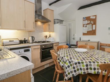 A kitchen with cabinets and appliances at Cloud Cottage in Ambleside