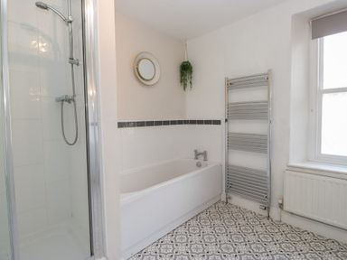 A bathroom with a shower and bathtub at Cloud Cottage in Ambleside
