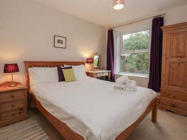 A bedroom with a bed and bedside tables at Cloud Cottage in Ambleside